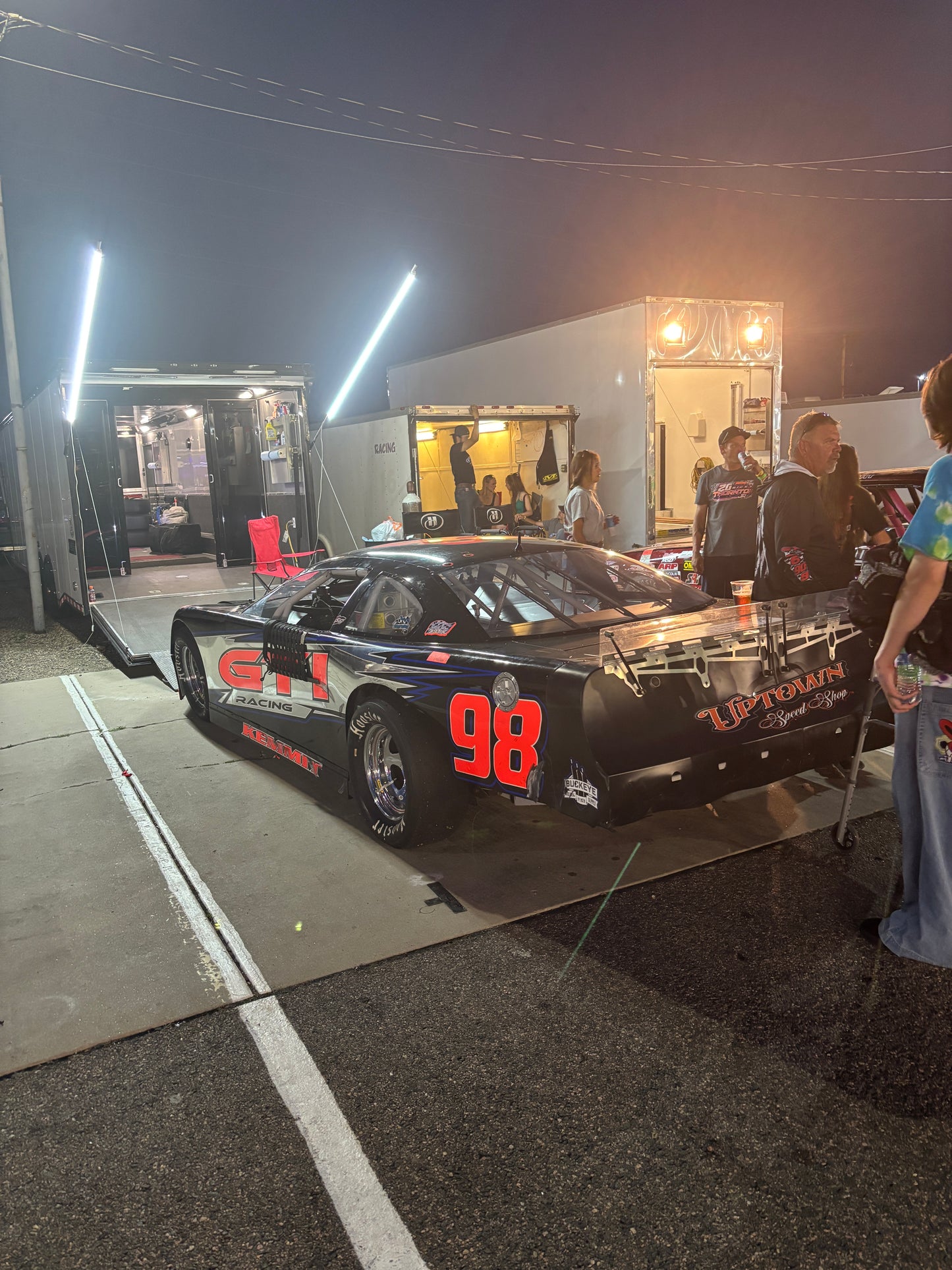 Race car with number 98 on a track at night