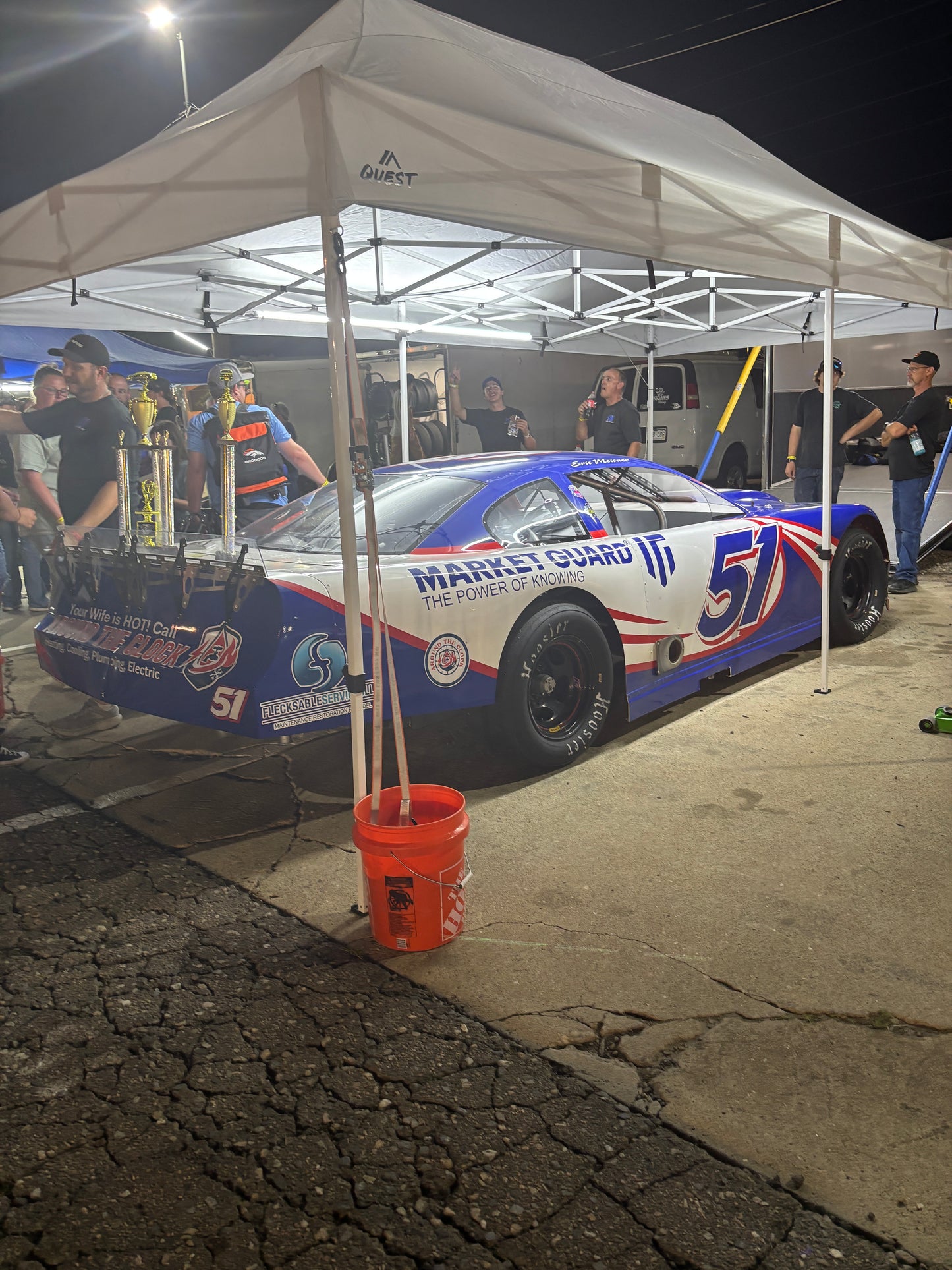 Racing car with number 51 on a stand at a race track with Canopy Pit Lights