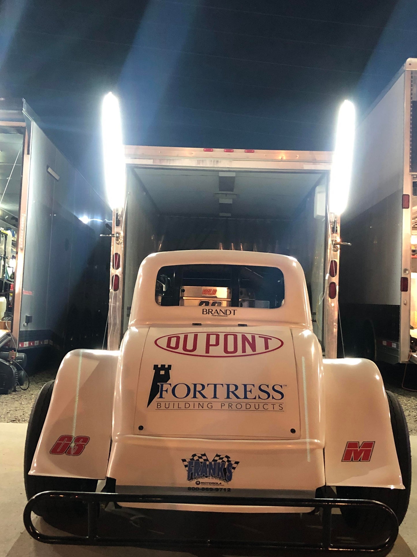 5FT Race Car Trailer Pit Light mounted on the back of a trailer, illuminated and casting light on the surroundings.